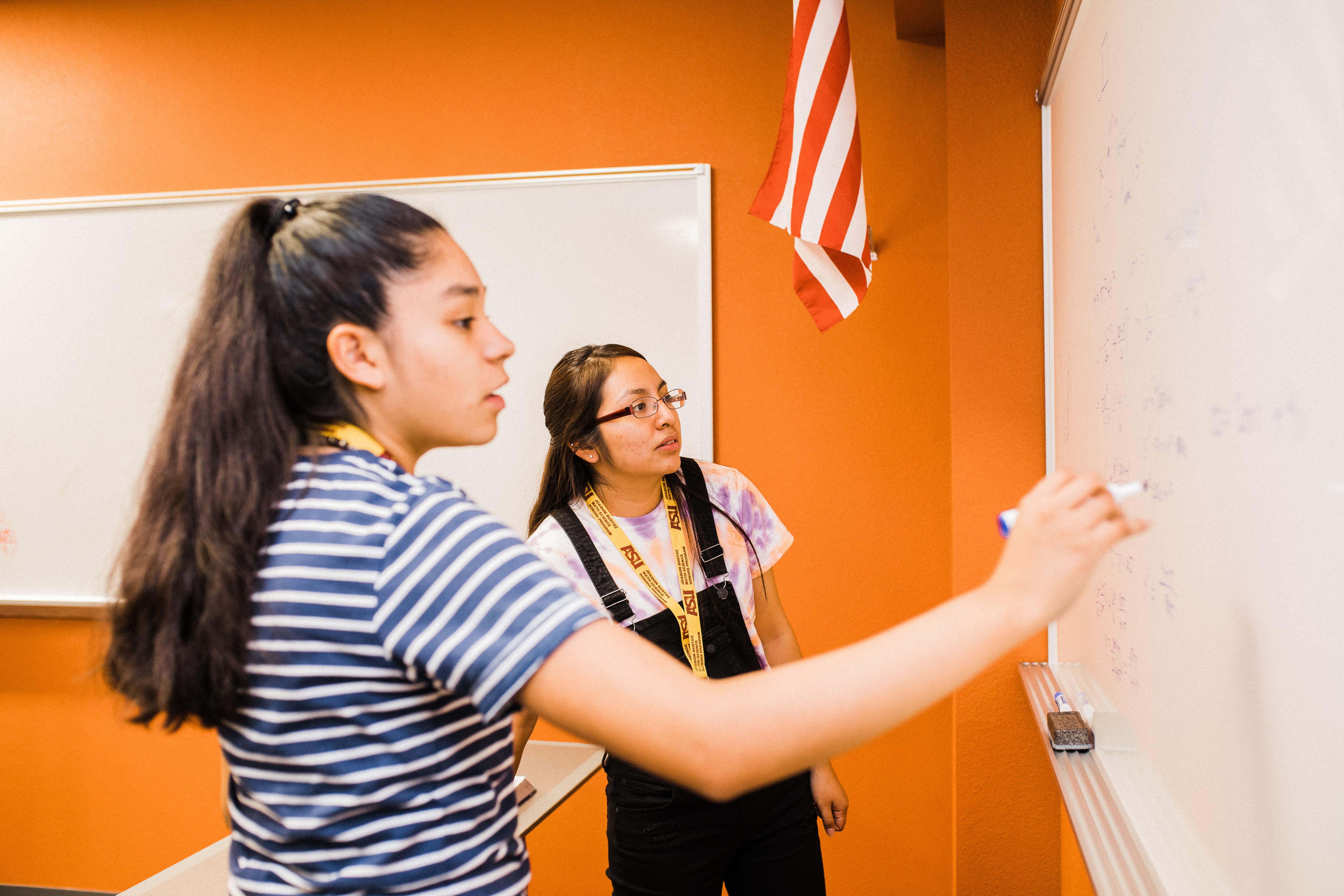 Two students at whiteboard